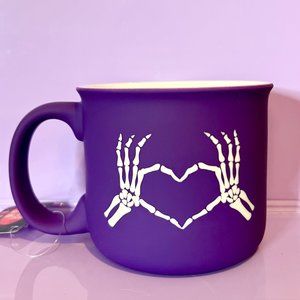 Skeleton hands showing love mug